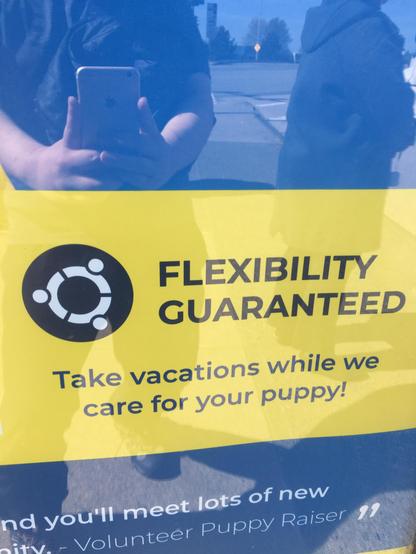 A billboard for a puppy raising service, but it's the Canonical Ubuntu Linux logo used.