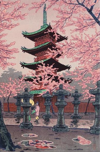 A view looking up at the five-story pagoda in Tokyo's Ueno Park, screened by branches of cherry trees full of blossoms. Parallel rows of stone lanterns line a narrow walkway at the base of the fenced-off pagoda; a pair of female figures pause on the path, one folding her umbrella closed. Puddles on the ground hint at a recent rain, while the sky above is overcast.