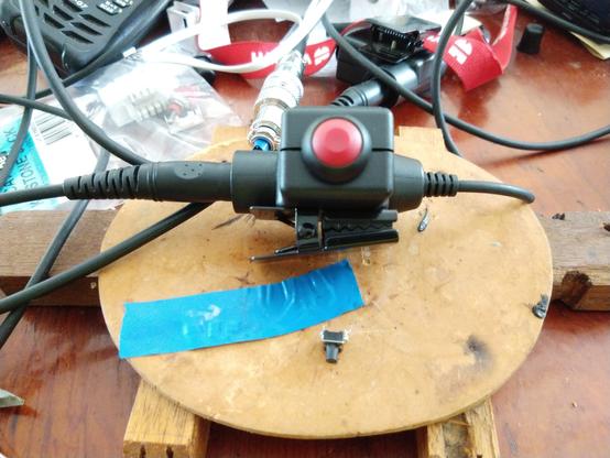 U94 PTT adaptor with a replaced pushbutton.  The new pushbutton is a red dome with a black bezel.