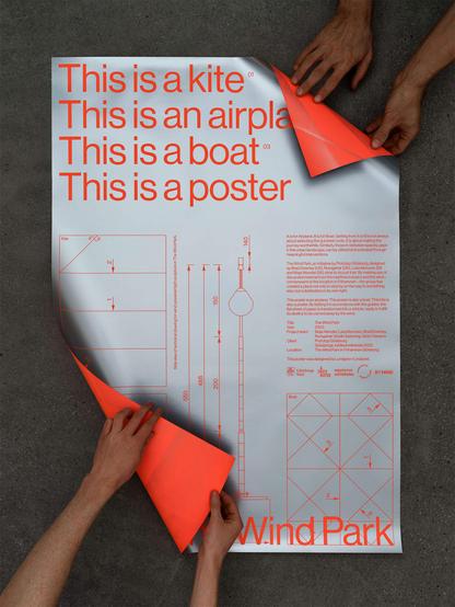 Three hands hold a poster with the text "This is a kite, airplane, boat, poster" in orange. Diagrams and instructions are visible underneath on a gray background.