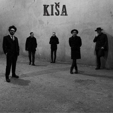 Kiša self titled debut cover album. Five musicians in black clothes standing on a concrete surface in front of a wall.