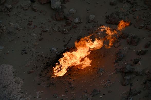 A flame burning in the dark