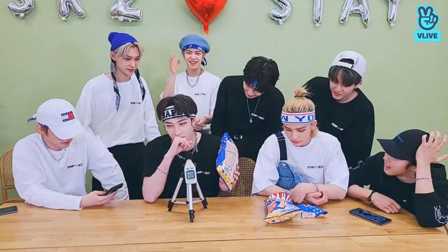Bang Chan attempts to eat a chip as quietly as possible while being recorded by a decibel meter. The other skz members are mostly watching him, apart from Seungmin who is standing behind him and silently dancing some of the Gods Menu choreo