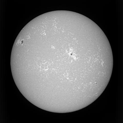 An image of the sun in the Calcium H band, shifted in continuum by 1 Å. A large active area is visible in the center, and a new one is coming from the eastern (left) limb.