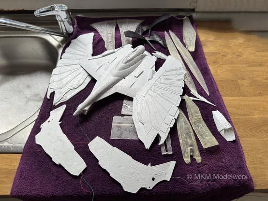 Various model parts sitting on a purple hand towel to dry