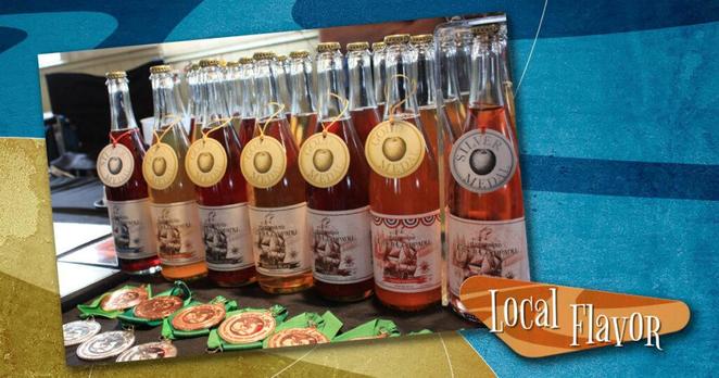 Bottles of various flavors of cider from the Port Townsend Cider Company, against a blue and gold background with the Around Seattle logo in the lower right.