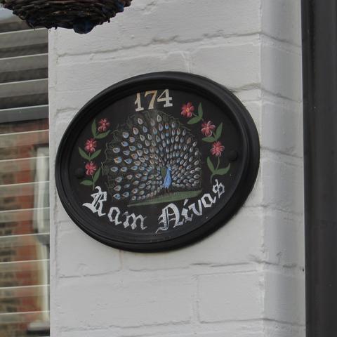 Ram Nivas (House of Ram) plaque featuring a peacock