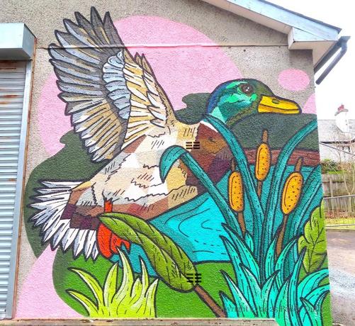 wall-painting showing a duck in flight above some reeds and a pond