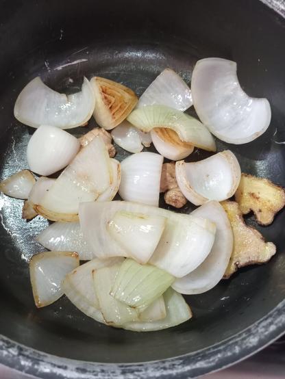 Ginger and onions frying on a pan