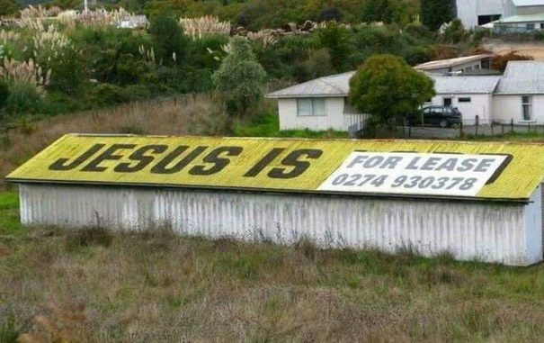 picture of a roof that you can rent for advertisement. 

The last word of the initial sign « JESUS IS … » is covered by a notice stating « FOR LEASE, 0274 930378 », such that the whole is read JESUS IS FOR LEASE, [number]