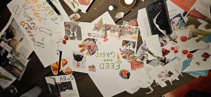 Collage with text: feed over greed
Many collage materials on wood table.