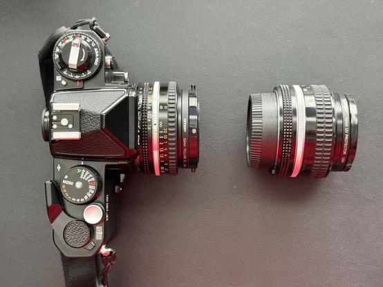 A photo of my camera from above with the pancake 50mm f/1.4 lens attached and the normal one sitting next to it.