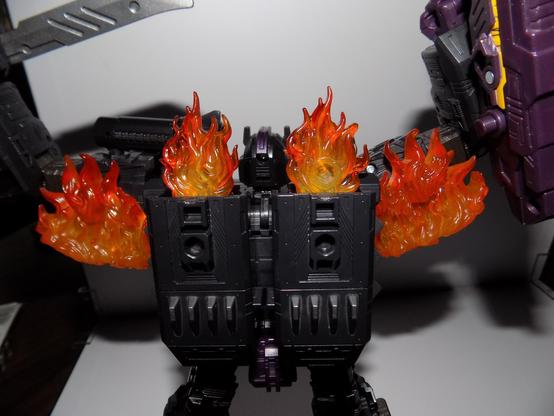 The back of an action figure with its arms up in the are like muscle flexing
