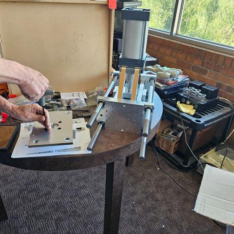 photo of the vise build in progress - there's a lot of machined aluminum parts and a SC100x100 pneumatic cylinder on top.