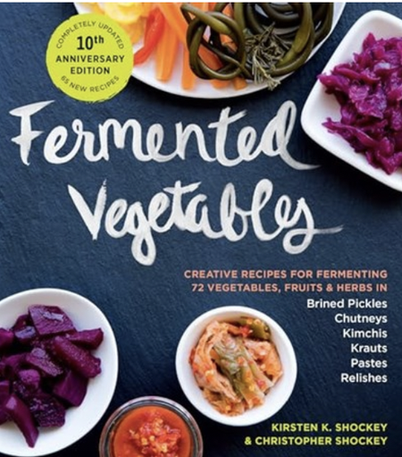 A dark blue cover, with bowls of fermented vegetables around the perimeter.  Beetroot, carrots, pastes, and more. Cursive white text for the title. Other text in orangey colour and white.