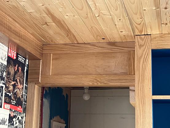 Wood work above a door opening.