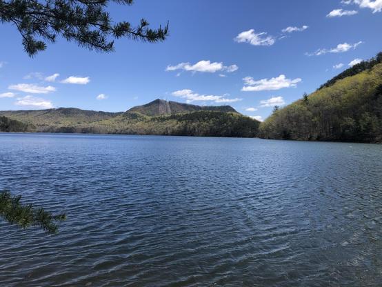 Green mountains across a blue lake.