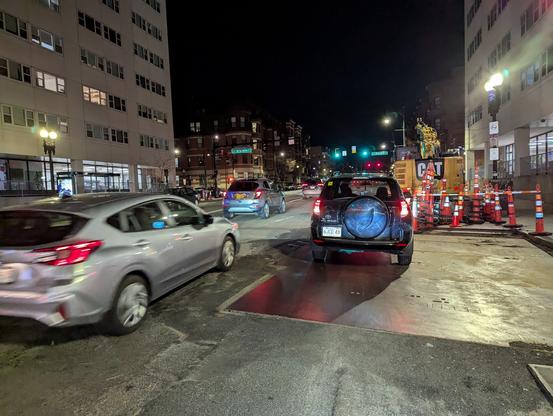 Driver blocking the bike lane while traffic speeds by. Construction to the right also blocking the way forward