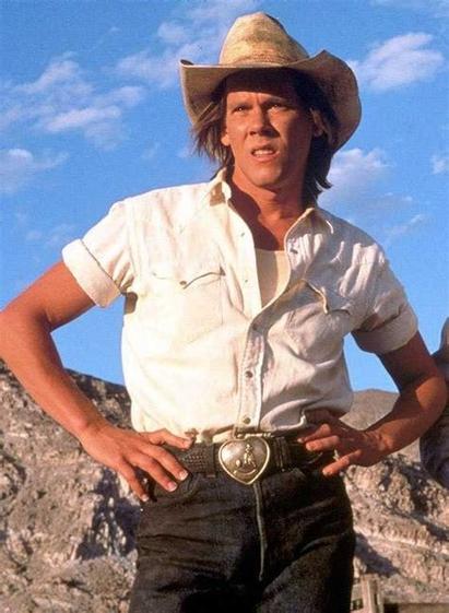 Kevin Bacon wearing modern day cowboy style clothes including the hat.