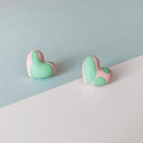 Heart earrings made out of jesmonite. They have a marble patern in pastel pink and mint green