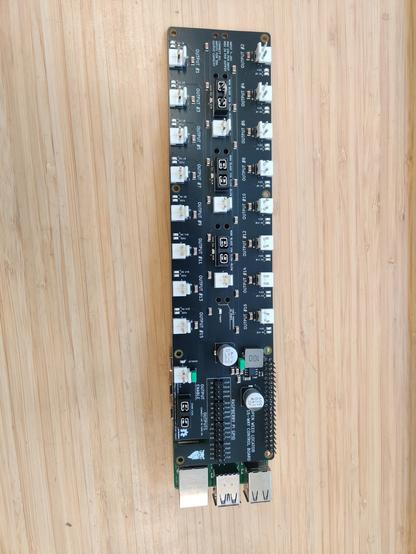 A long thin black PCB with 16 white connectors