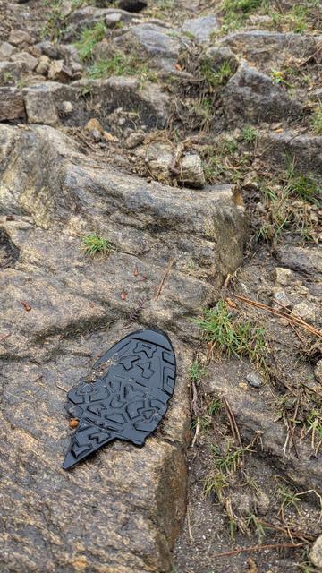 A shoe sole laying on granite stone, this track kills shoes, second shoe died on this trail, lucky mine survived