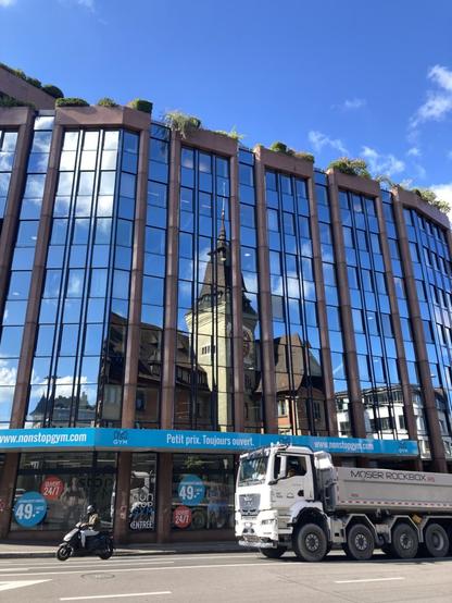Reflection of an old Geneva building in a new one