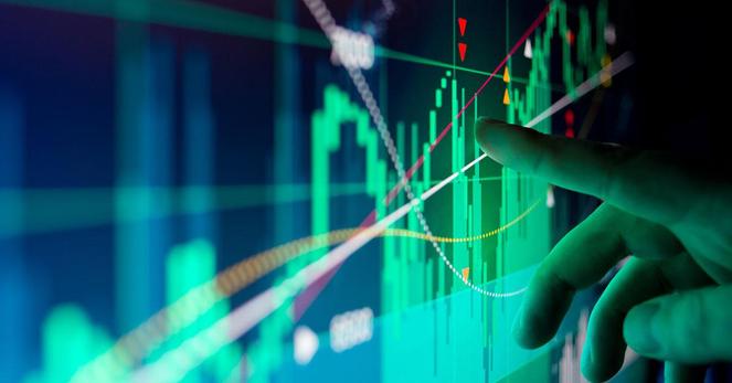 A stock image of a finger pointing at data points on a graph.