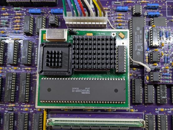 Photo of the MiniPerformer+ mounted on a cloned Mac Plus board.
It mounts in place of the CPU, has a 68882 and a 68030 on top (plus the original CPU). The new CPU and FPU have heathsinks on.