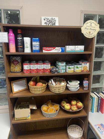 A picture of a bookshelf with 4 shelves featuring assorted types of foot and basic supplies.