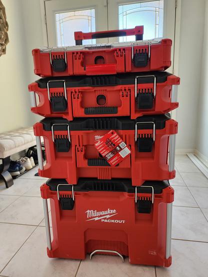 Picture shows milwaukee packout workshop storage system with 4 toolboxes stacked on top of one another.