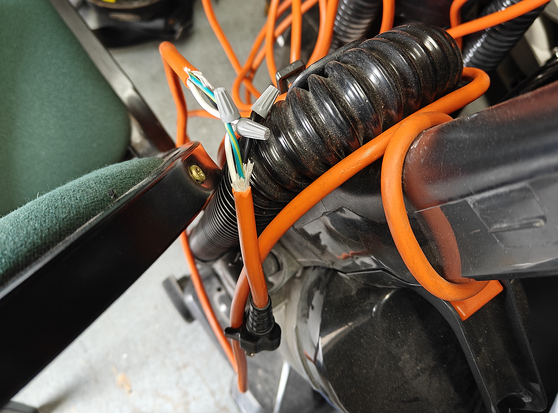 Orange extension cord spliced with wire nuts.