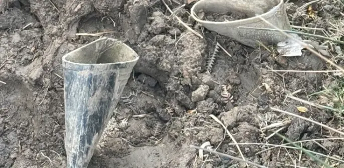 Photo of wellies stuck in mud up to the top of the boot. I spotted these on a walk across some open access land in Pencoed.