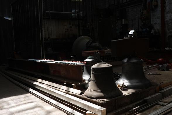 Three bells and other equipment stored in the workshop.