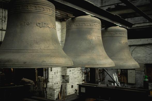 A set of three bells, named Gerard, Peter and Patrick, hanging from a steel frame.
