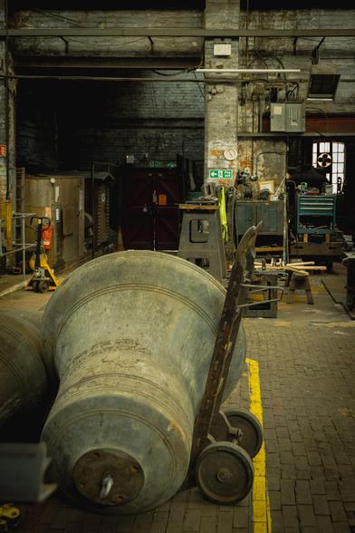 An old bell lying on a trolly in the workshop.