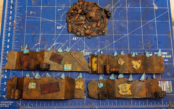 One pile of rusty metal rubbish, and four different angly pointy barriers. The barriers have blue triangular bit bolted on top of them and some yellow plates with graffiti or shapes in relief bolted on the sides. The whole thing is very rusty. It's like these orcs don't know how to apply sanding paper and a bit of oil. These could have been shiny ass barriers. But orc homekeeping apparently is not very much concerned with keeping things shiny.
