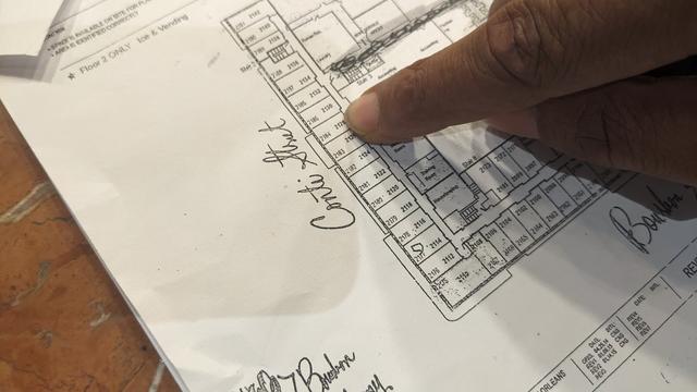 hotel map with finger pointing at room nunber