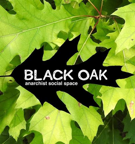 The words Black Oak Anarchist Social Space written on a black oak leaf