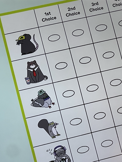 A photo of a commercial for NYC’s ranked choice voting. On the fake ballot are cartoons of “candidates” including a rat, a cat, a pigeon, and more that are not displayed.