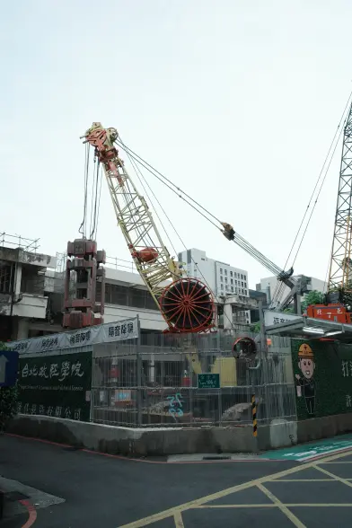 A construction site in central Taipei, with cranes outlined against the sky