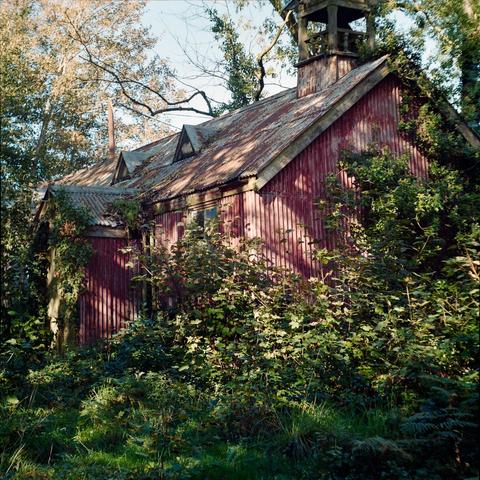 red tin chapel, overgrown and unkept
