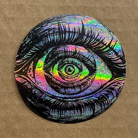 INNERVIEW Holographic sticker of eyes within eyes on cardboard