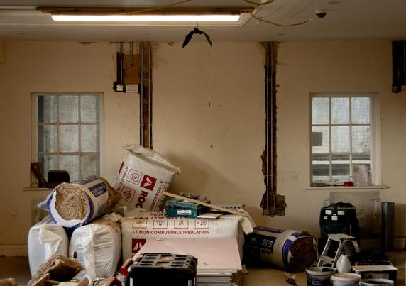 A space undergoing refurbishment: various building materials stacked on the floor.
