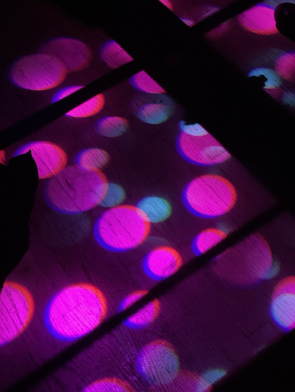 Pink and blue colored dots from a nightclub spotlight