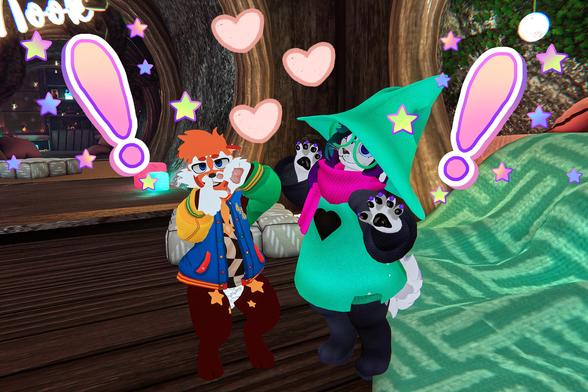 The photo shows two anthropomorphic characters in a virtual environment. One character, with orange hair and a colorful jacket, is standing near a counter or bar. The other character, wearing a teal hooded cloak and a pink scarf, is standing nearby. Both characters appear to be expressing excitement or surprise, indicated by the exclamation points and hearts floating around them. The setting appears to be a whimsical, possibly fantasy-themed, virtual world.