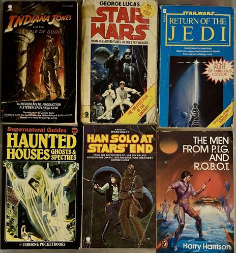 A collection of six vintage paperback books, including titles related to "Indiana Jones and the Temple of Doom," "Star Wars," "Return of the Jedi," "Han Solo at Stars' End," and "The Men from P.I.G. and R.O.B.O.T.