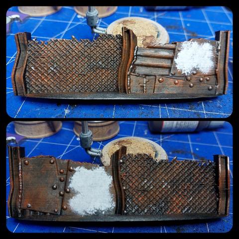 Scrap barrier that consists of three H beams upright worth between two of them chain link fence and between the other two a number of metal plates welded across one another. One of the plates appears to have been white but is very rusty and the rest of the thing is just a symphony of rust colors