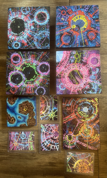 10 small acrylic geometric abstract paintings in many colors mostly featuring complex circular line graphics