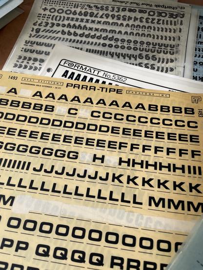 A stack of transfer lettering sheets. On top is “PARA-TIPE” brand in the Microgramma style.